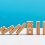 Wooden dominos with light bulb symbol.